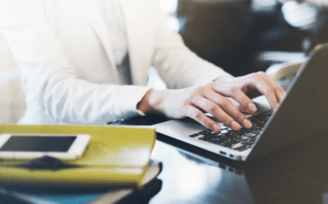 person typing on laptop keyboard